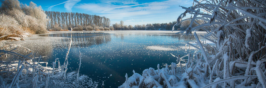Ein gefrorener See vor blauem Himmel